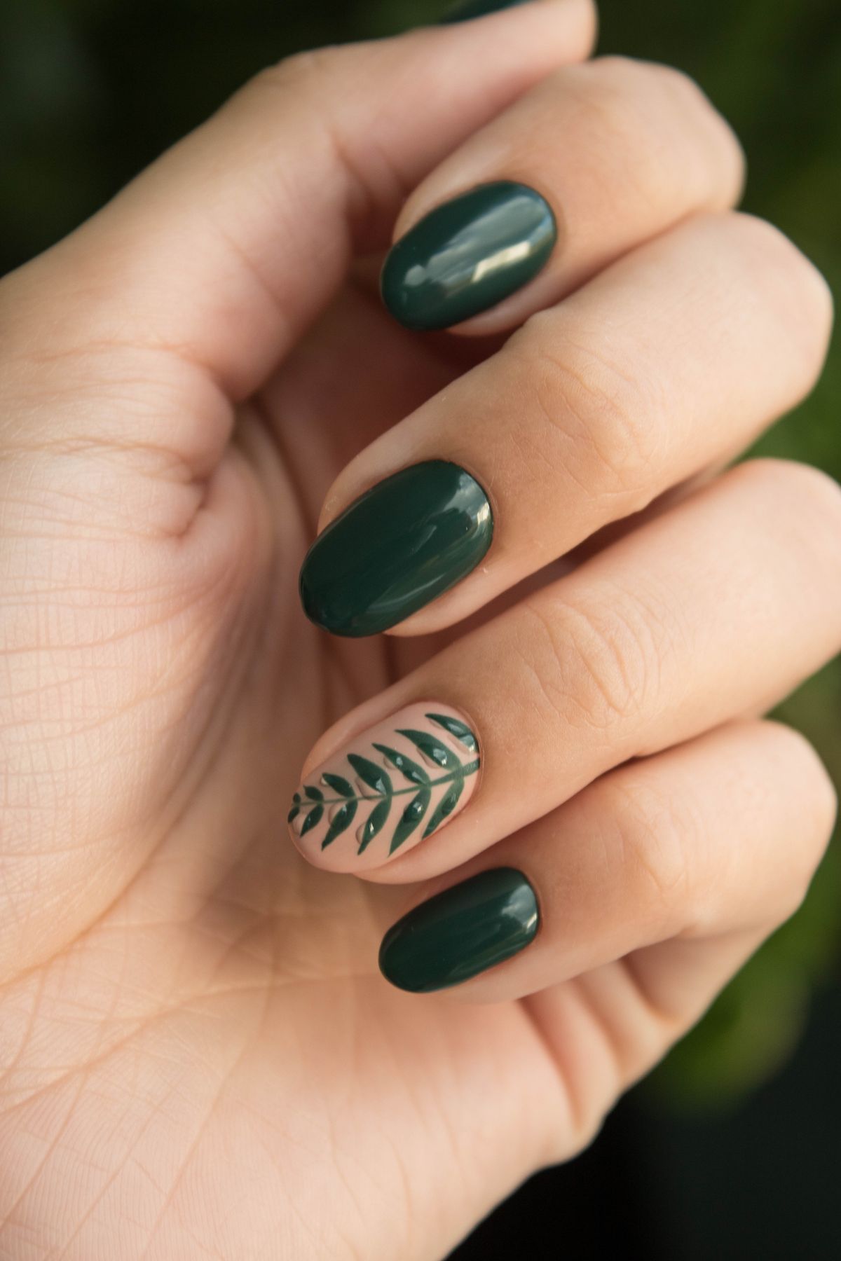 Freehand hand-painted nail art with a leaf design